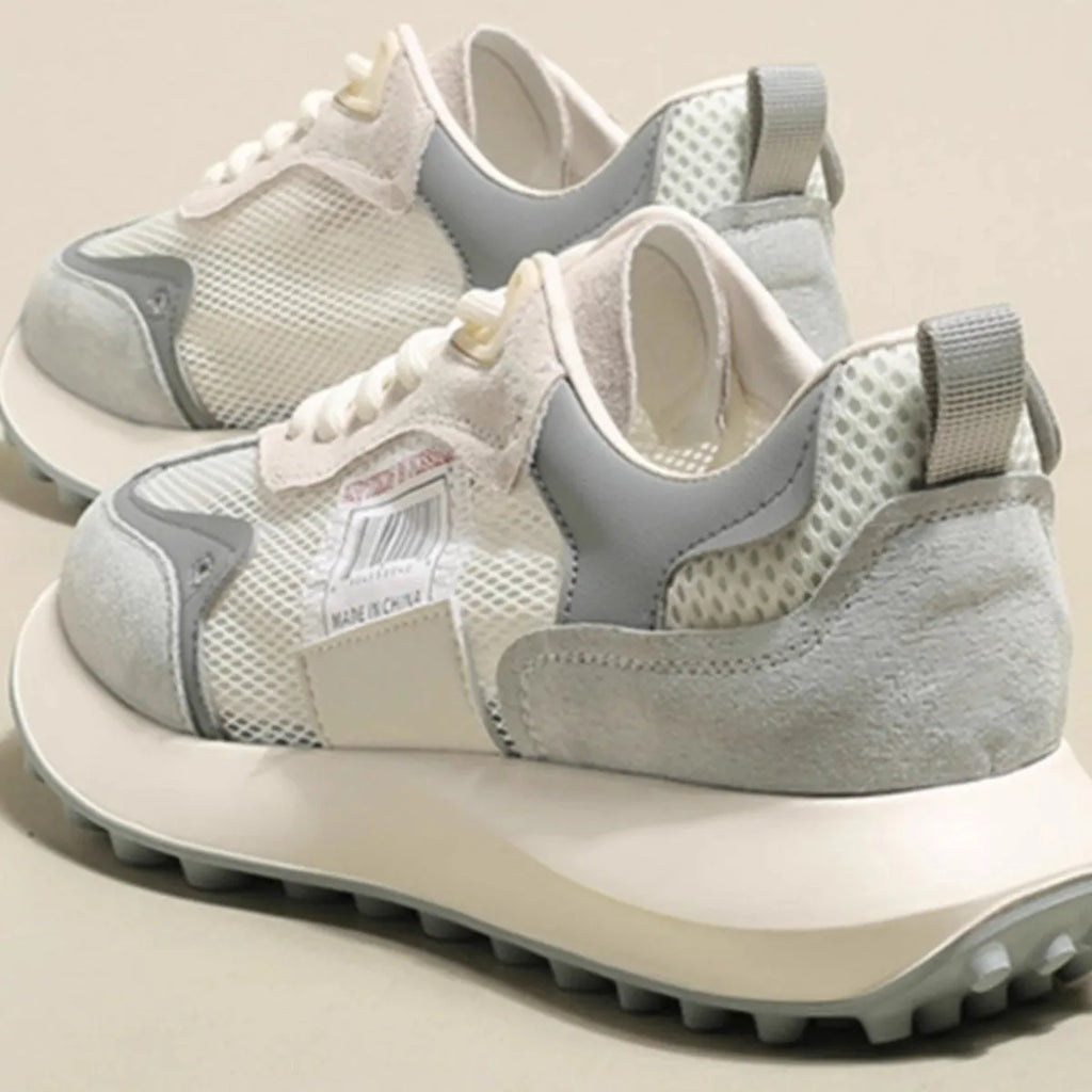 Women's pink and grey retro low-top sneaker with round toe and flat rubber sole.