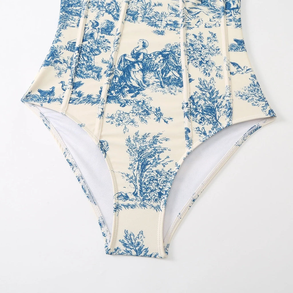 Blue women's one-piece swimsuit with a matching separate gauze skirt laid flat.