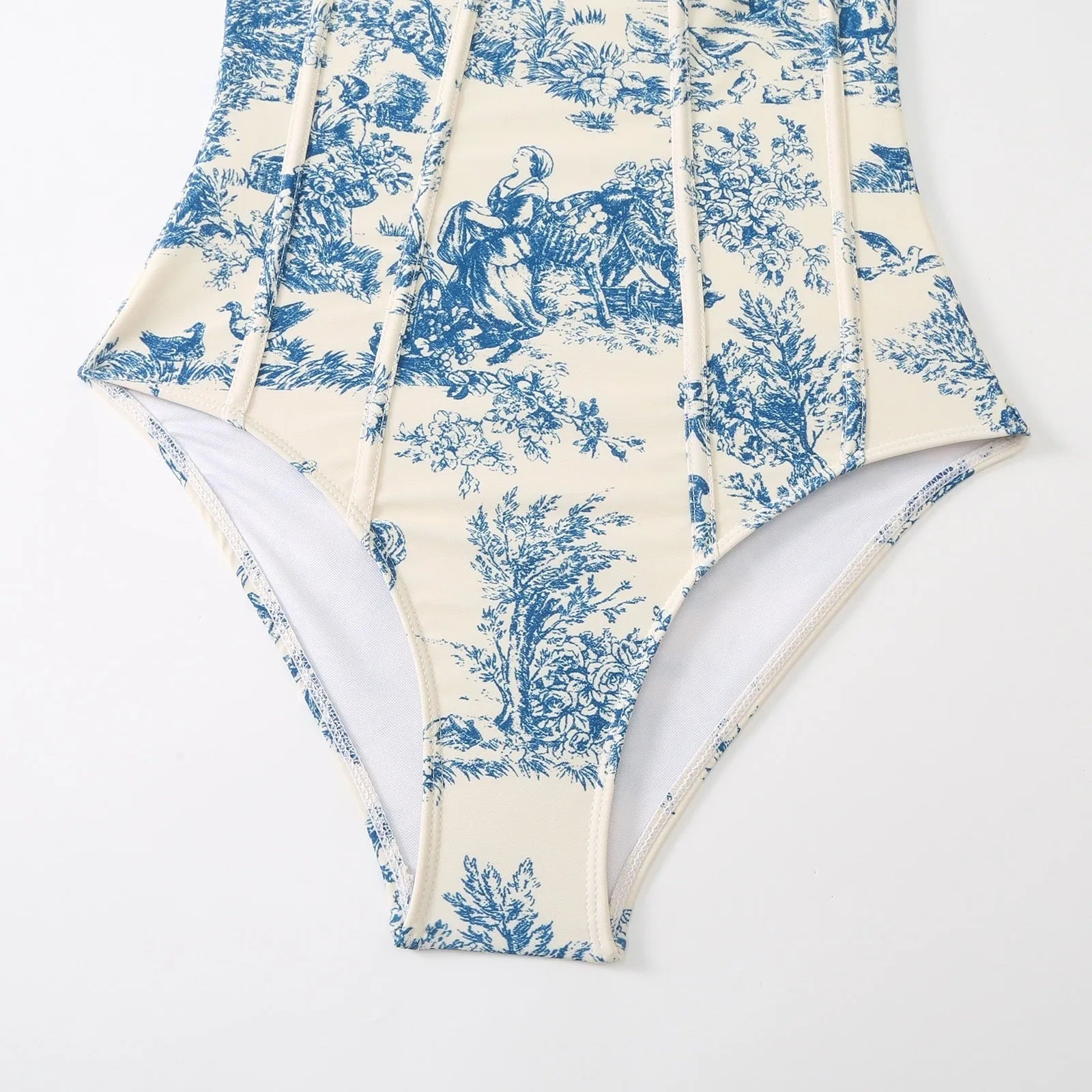 Blue women's one-piece swimsuit with a matching separate gauze skirt laid flat.