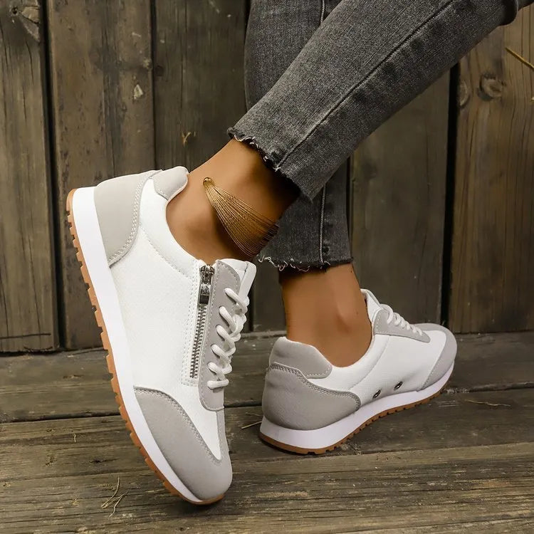 Women's flat shoes in champagne, grey or white with artificial PU upper and rubber sole.