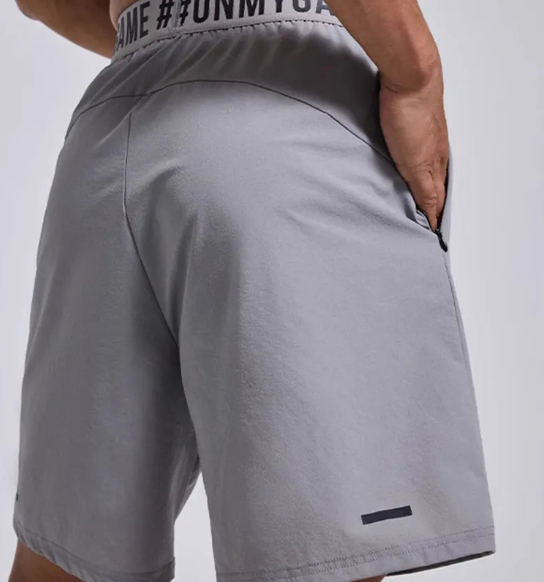 Men's loose black sports shorts with elastic waistband and letter detailing, shown front view.
