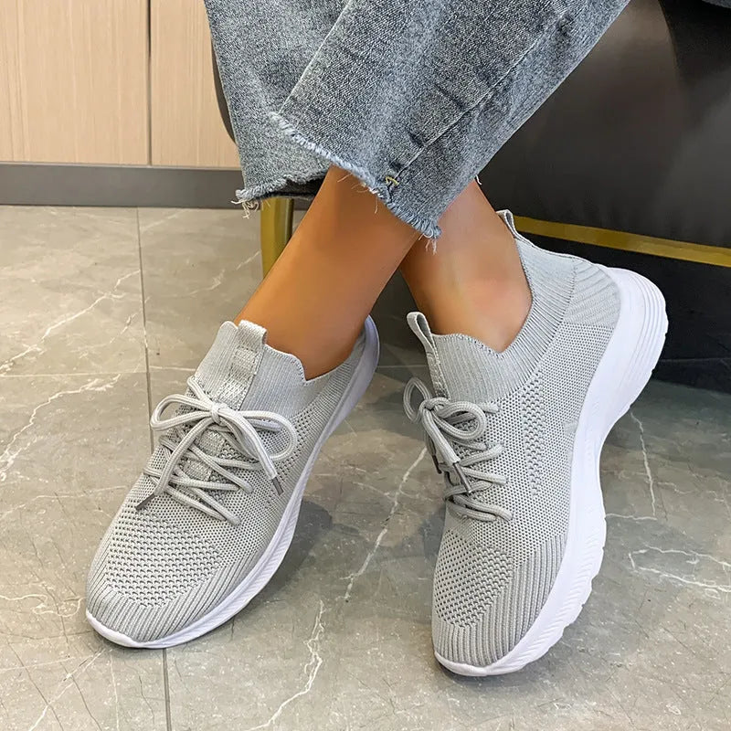 Women's low-top mesh breathable tennis shoes in creamy white, orange, and gray colours.