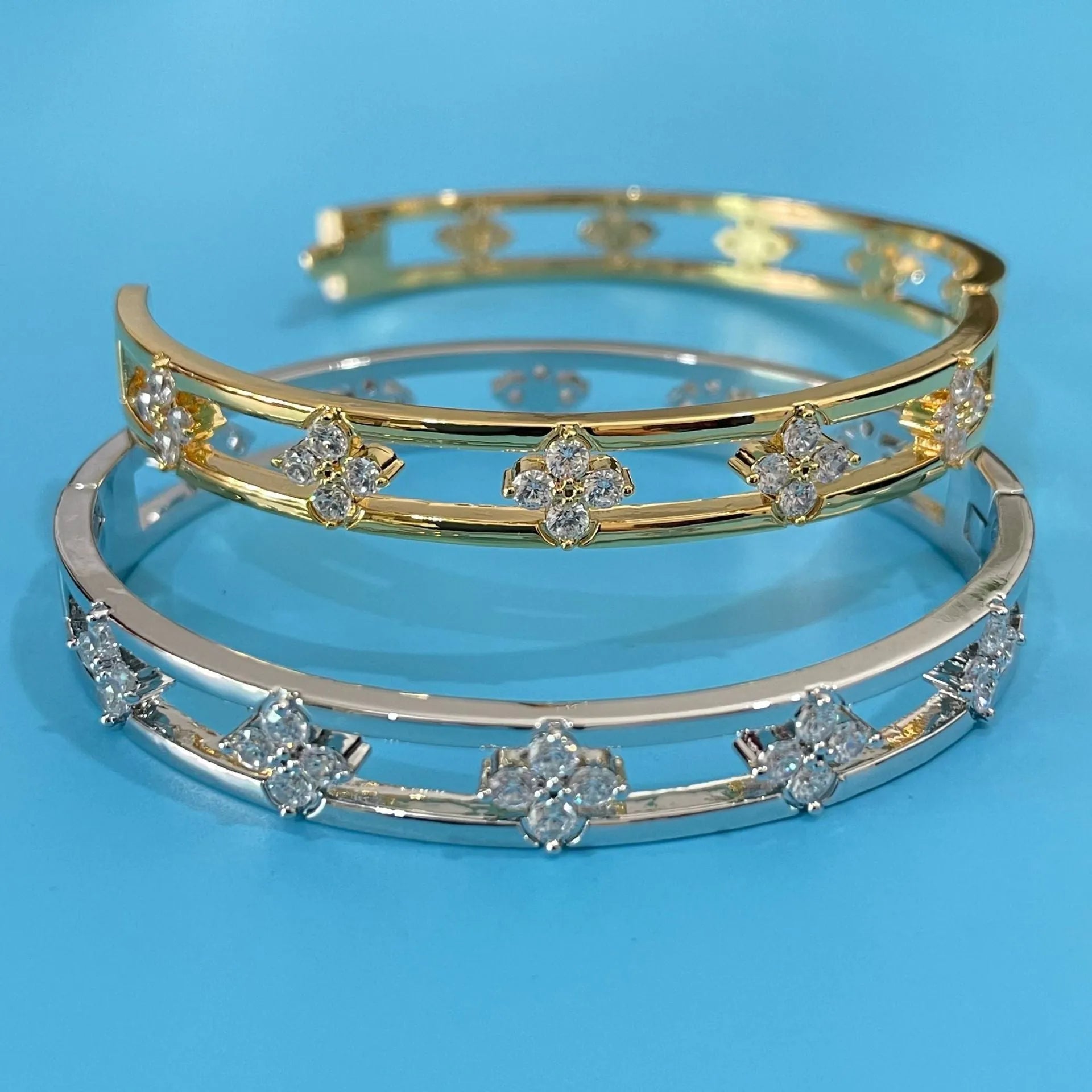 Gold and silver hollow women's bracelets with four-leaf clover charms and zircon stones.