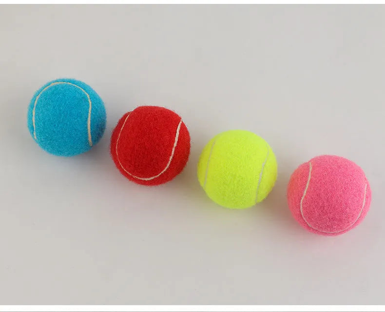 Bright pink durable rubber dog tennis ball with bite-resistant design for aggressive chewers.