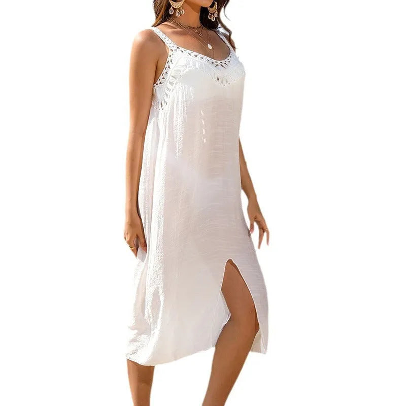 White crochet beach dress with hollow weave pattern and bottom slit, shown as a swimsuit cover-up.