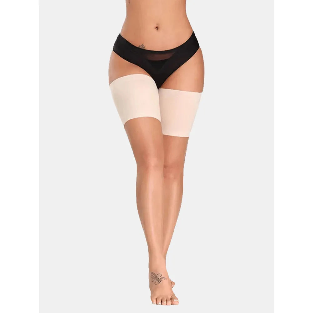 Women's anti-friction silicone thigh strap in black with adjustable nylon band on plain background