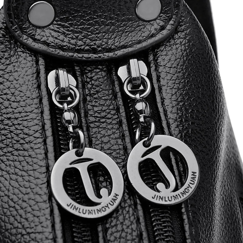 Large black women's shoulder bag with multiple compartments and luggage-inspired styling