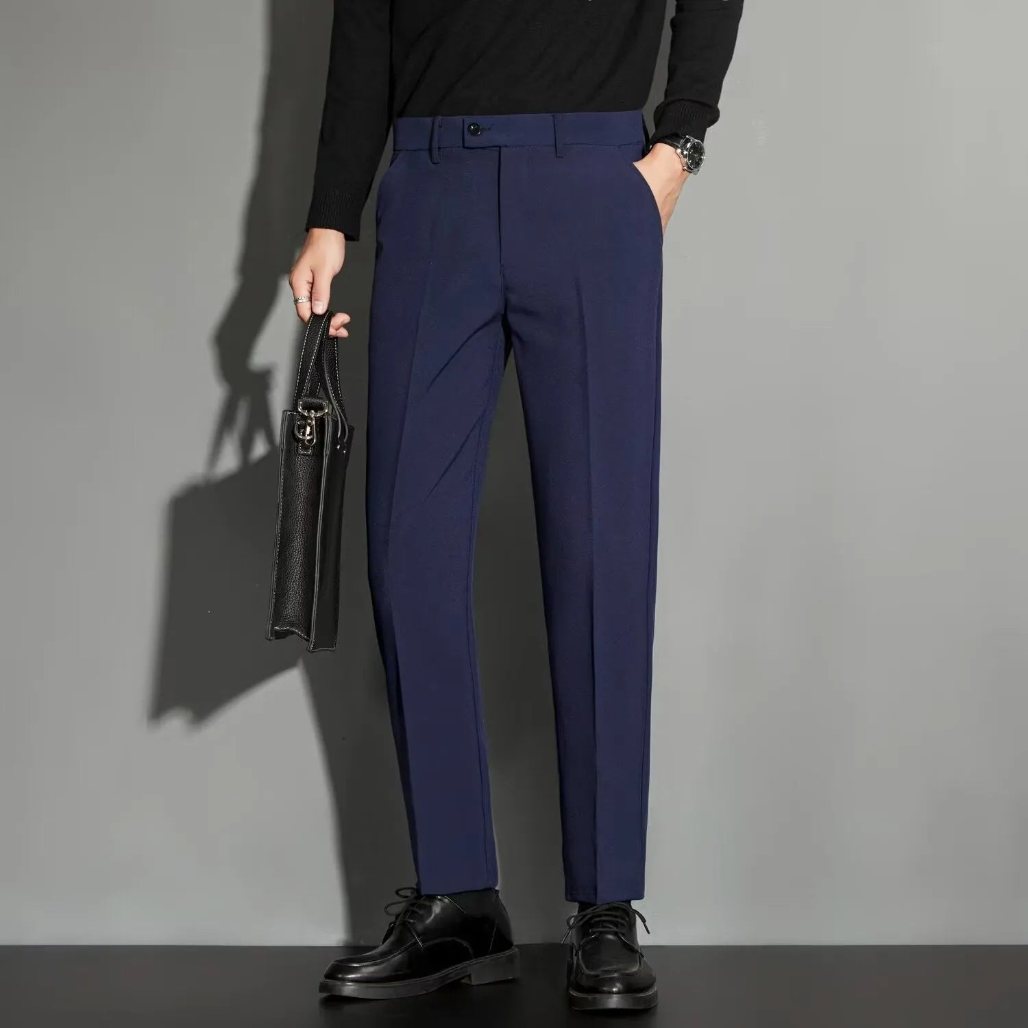 Man wearing apricot-coloured straight-leg suit trousers with an ankle-length draping effect.
