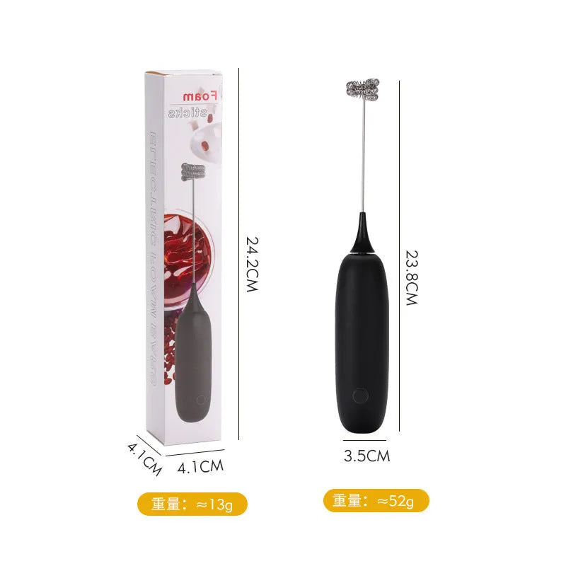 Black and white handheld electric milk frother with whisk attachment for coffee and beverage preparation