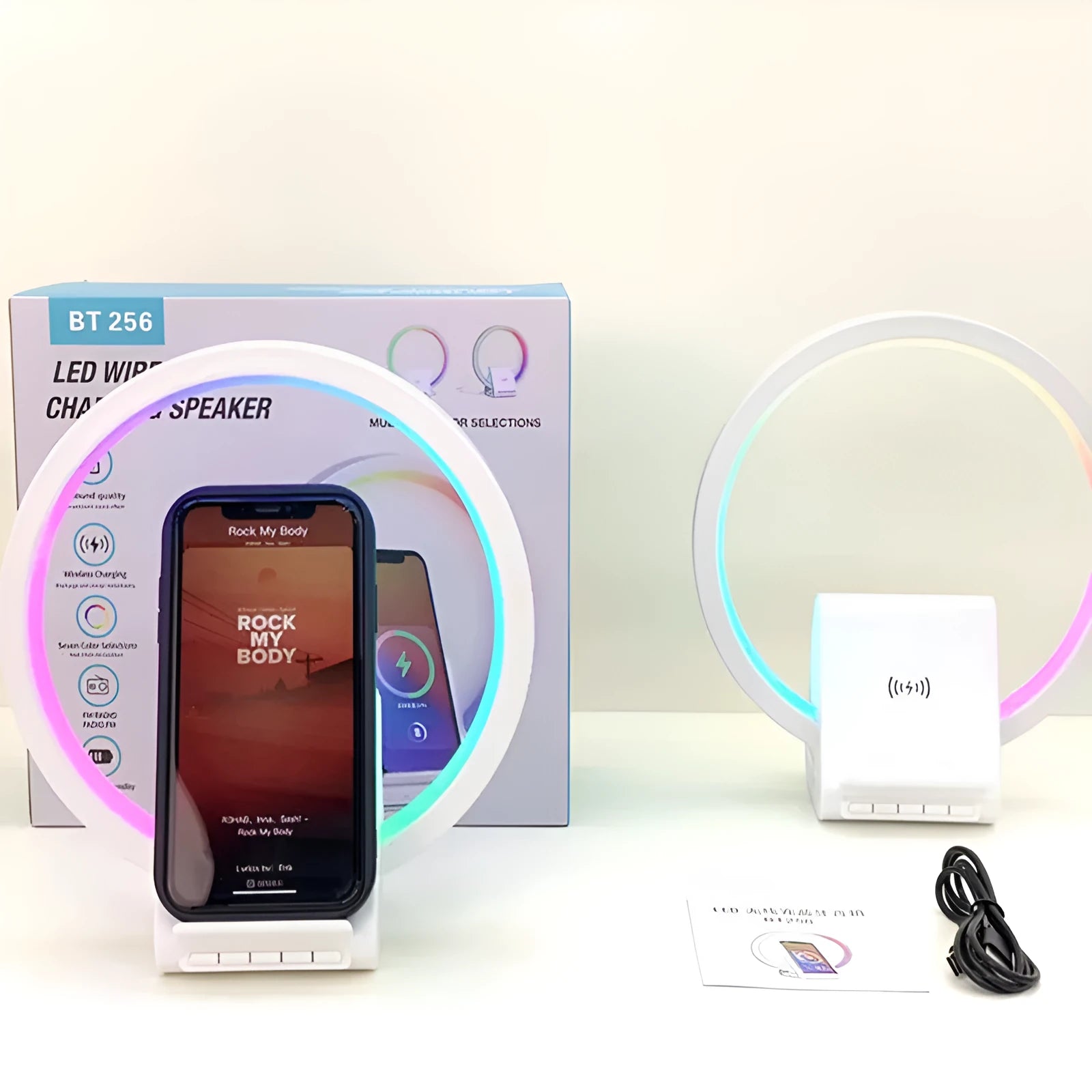 White smart Bluetooth speaker with 15W wireless charging surface and USB port on desktop