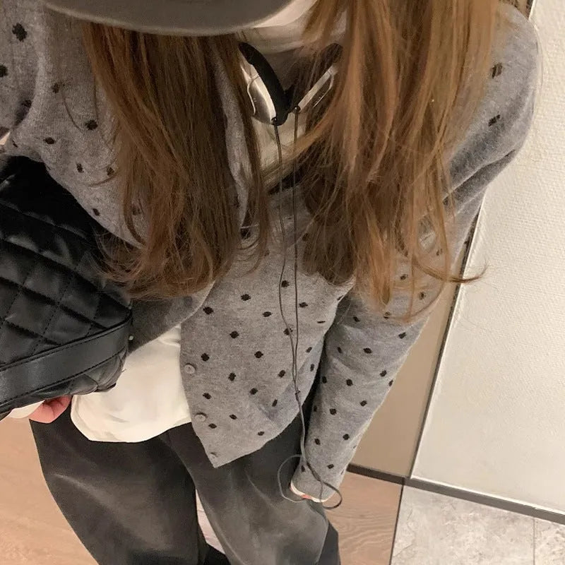 Women's grey dot knitted cardigan with crocheted flower detail and long sleeves