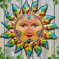 Iron wall hanging featuring a detailed sun face design in one of five available colour finishes.