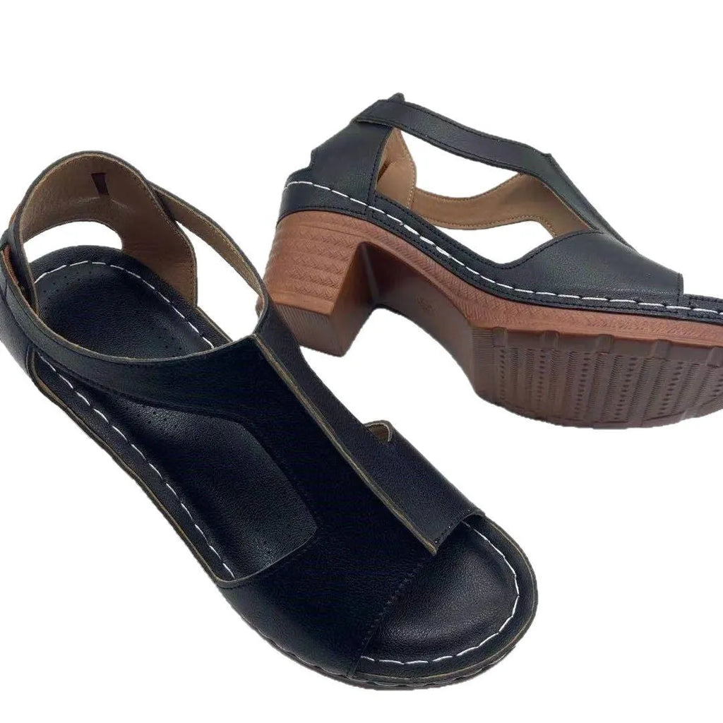 Women's white peep toe wedge sandals with Roman-style buckle ankle straps on a low heel.