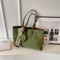 Large capacity polyester shoulder bag in green colour showing horizontal square shape and shoulder strap