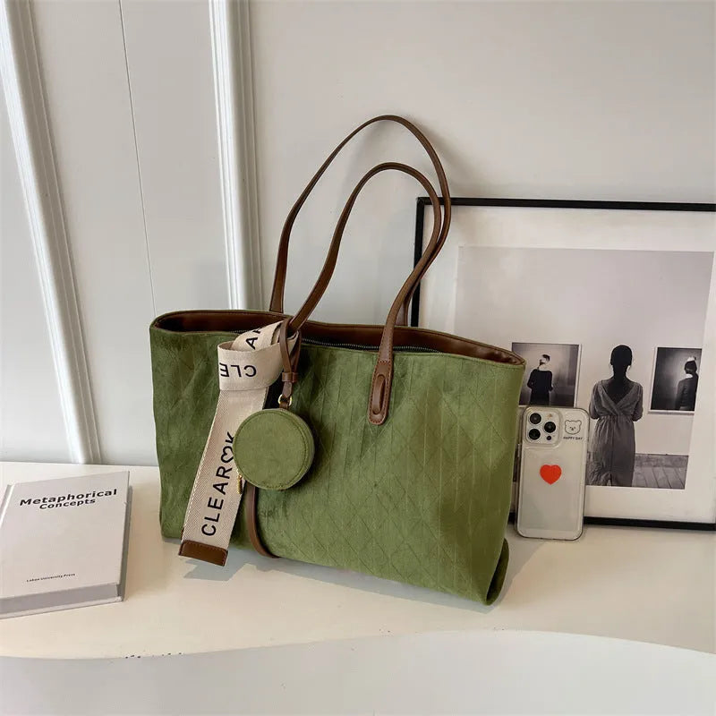 Large capacity polyester shoulder bag in green colour showing horizontal square shape and shoulder strap