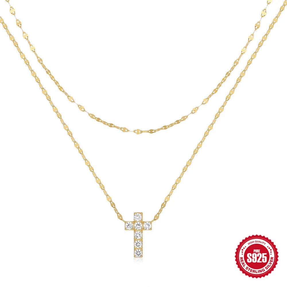 S925 sterling silver double layer twin diamond cross pendant on a clavicle chain, shown in gold and white gold finishes.