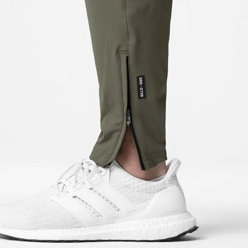 Men's loose-fit ankle-tied trousers in olive green, suitable for fitness and casual wear.