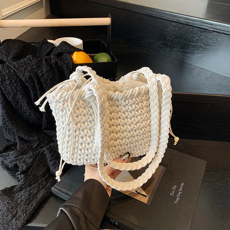 Knitted bucket shoulder bag in beige with external sandwich pocket and sewing thread detail for women
