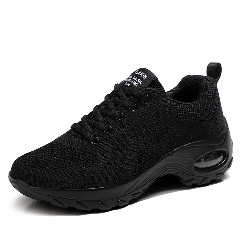 Women's red and black round toe lace-up mesh sneakers with low top and flat mid heel.