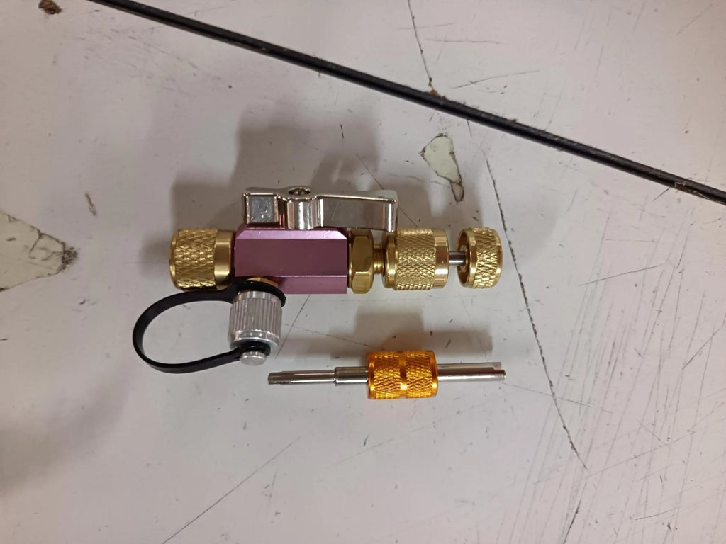 Metal vacuum valve core disassembly tool set showing black and pink valve removers