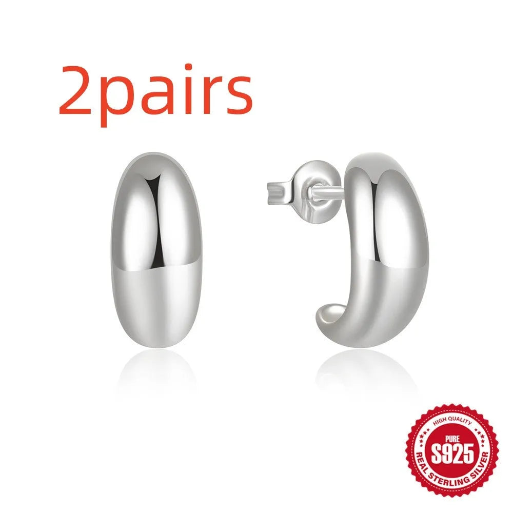 Sterling silver C-shaped stud earrings with glossy electroplated finish in gold or white gold