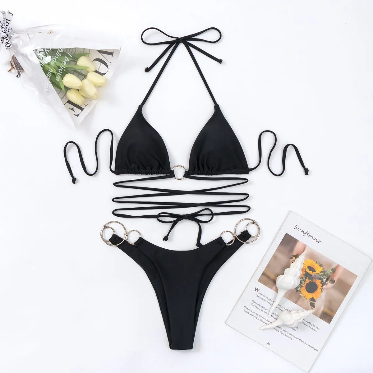 Black women's backless bikini set with long straps and metal ring details