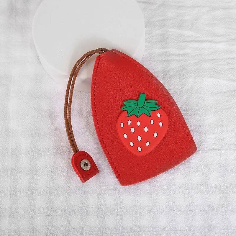 Colourful cartoon pull-out key protector case made from PU leather, showing a selection of fruit and animal designs.