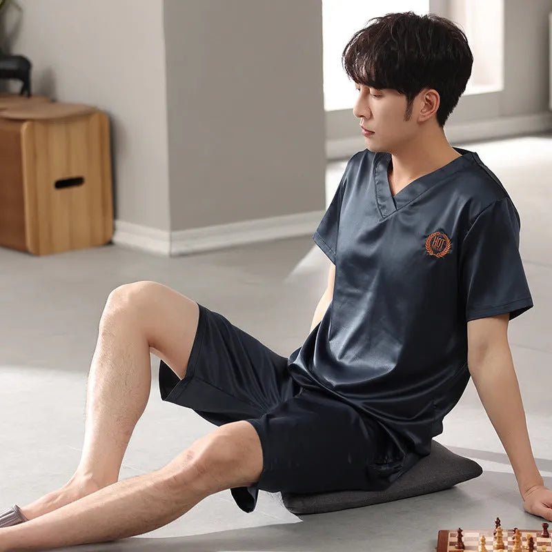 Man's loose blue ice silk short-sleeved pyjama shirt and matching shorts laid flat