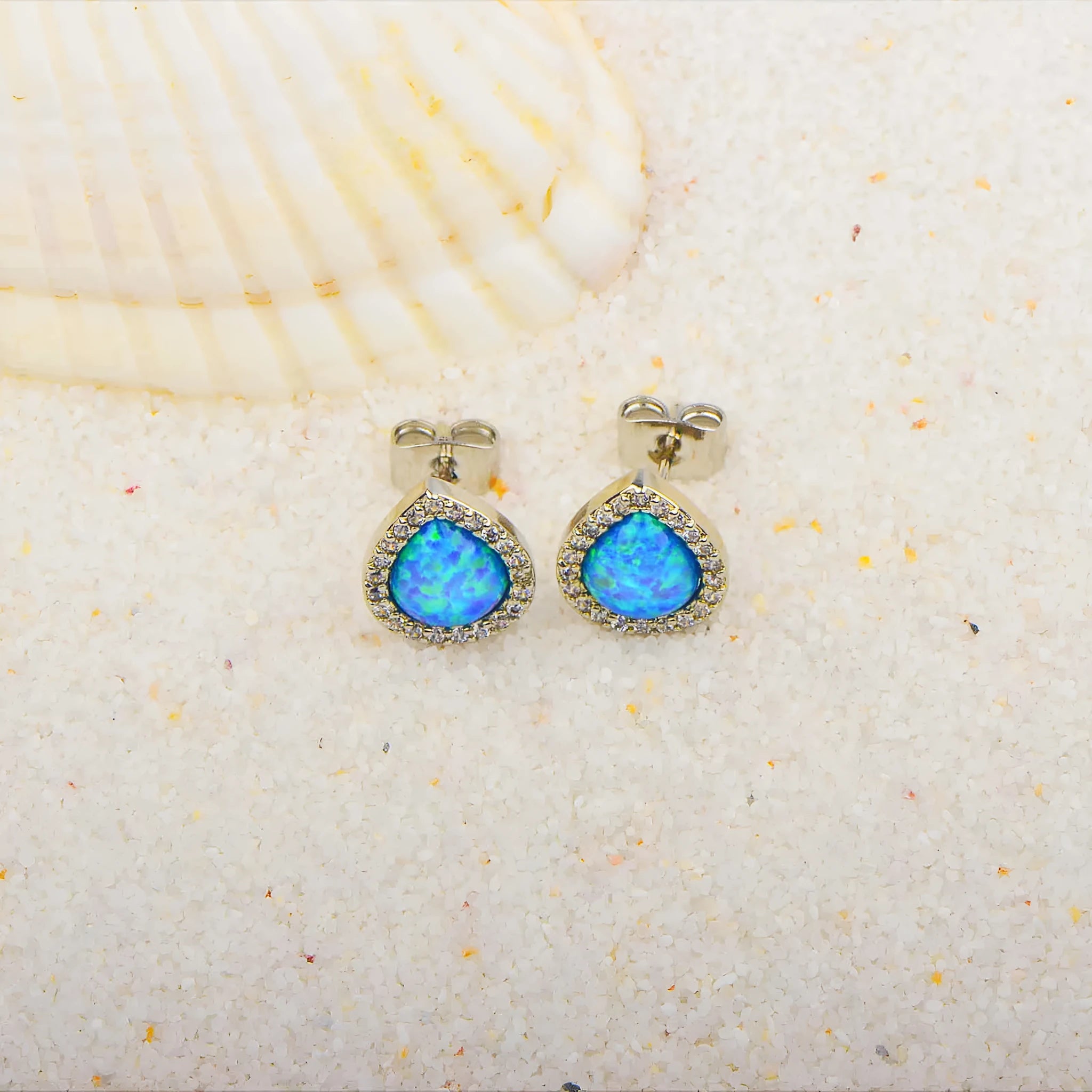 Blue opal drop-shaped stud earrings on copper base with inlaid gem setting