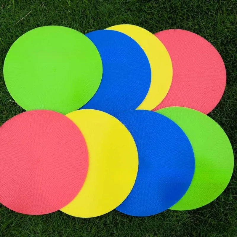 Yellow soft TPE football training target disc lying flat on grass