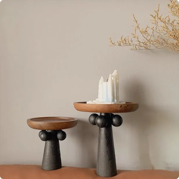 Nordic high-legged wooden round tray displaying candles and perfume bottles