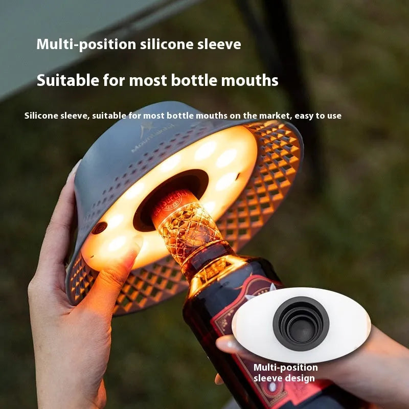 Beige wine bottle-shaped rechargeable camping lantern showing its size and USB-C port.