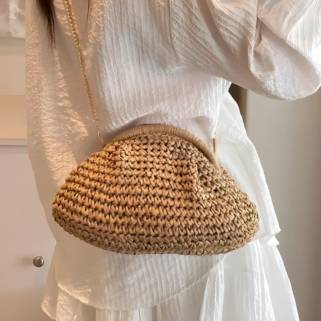 Shell-shaped straw shoulder bag with chain detailing and internal zipper pocket