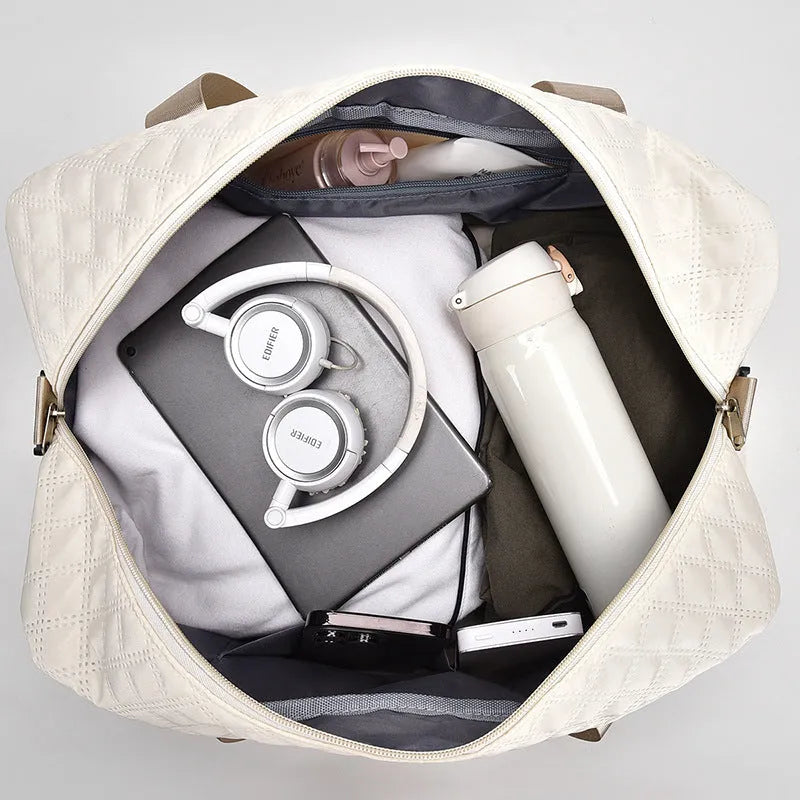 Large grey and pink Oxford cloth leisure travel bag with sewing thread detail on a white background.