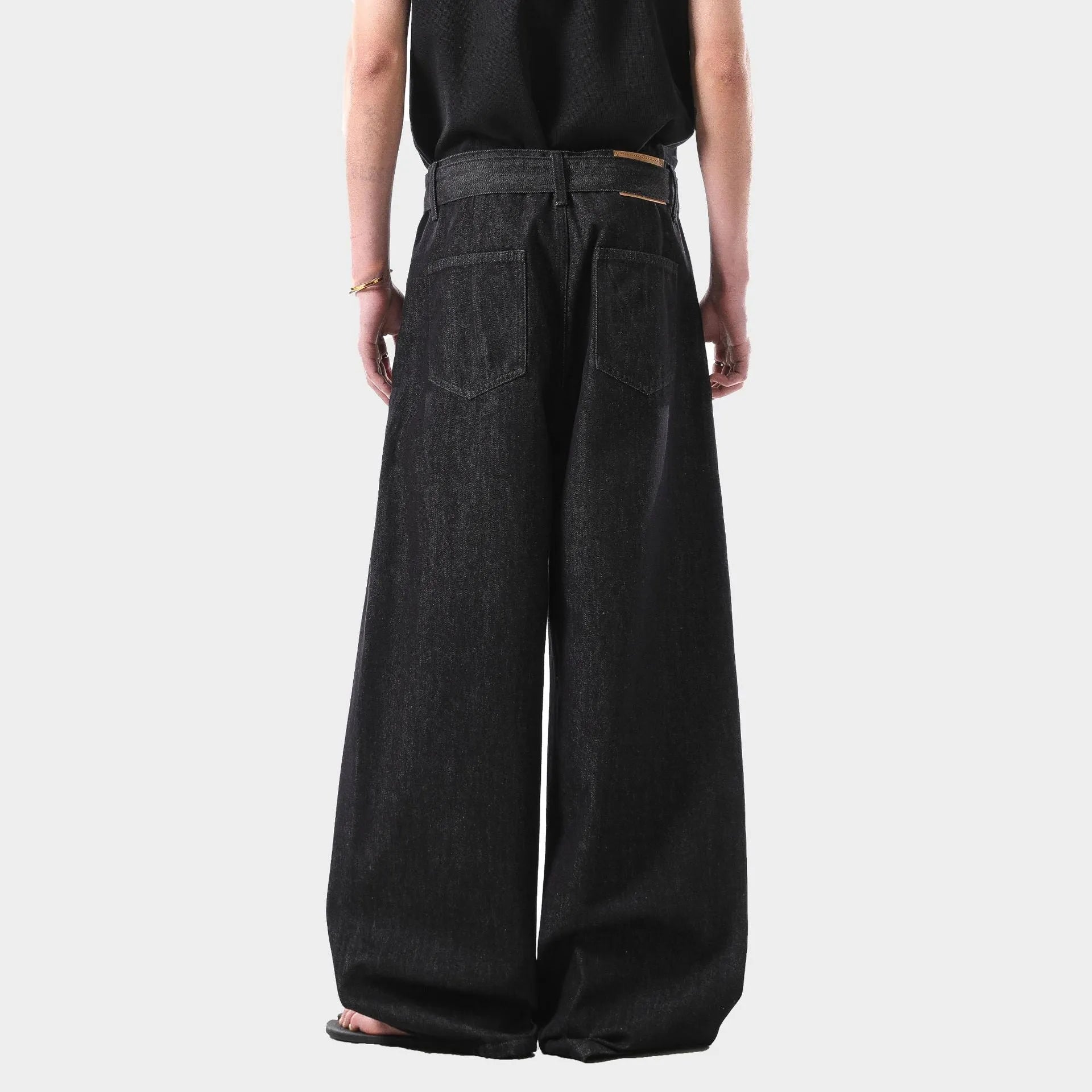 Black high-waist straight-leg denim jeans with a zip fly on a plain background.