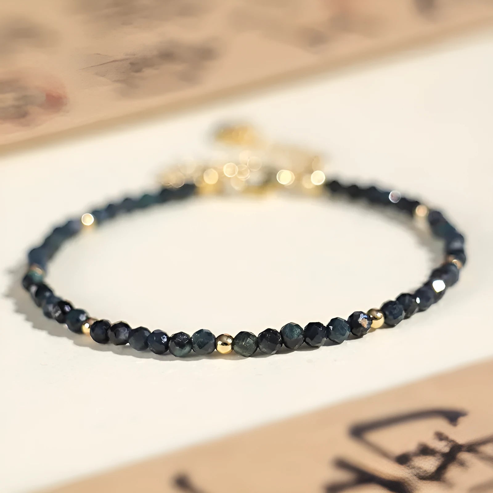 Blue tourmaline beaded bracelet with silver spacer beads and adjustable clasp