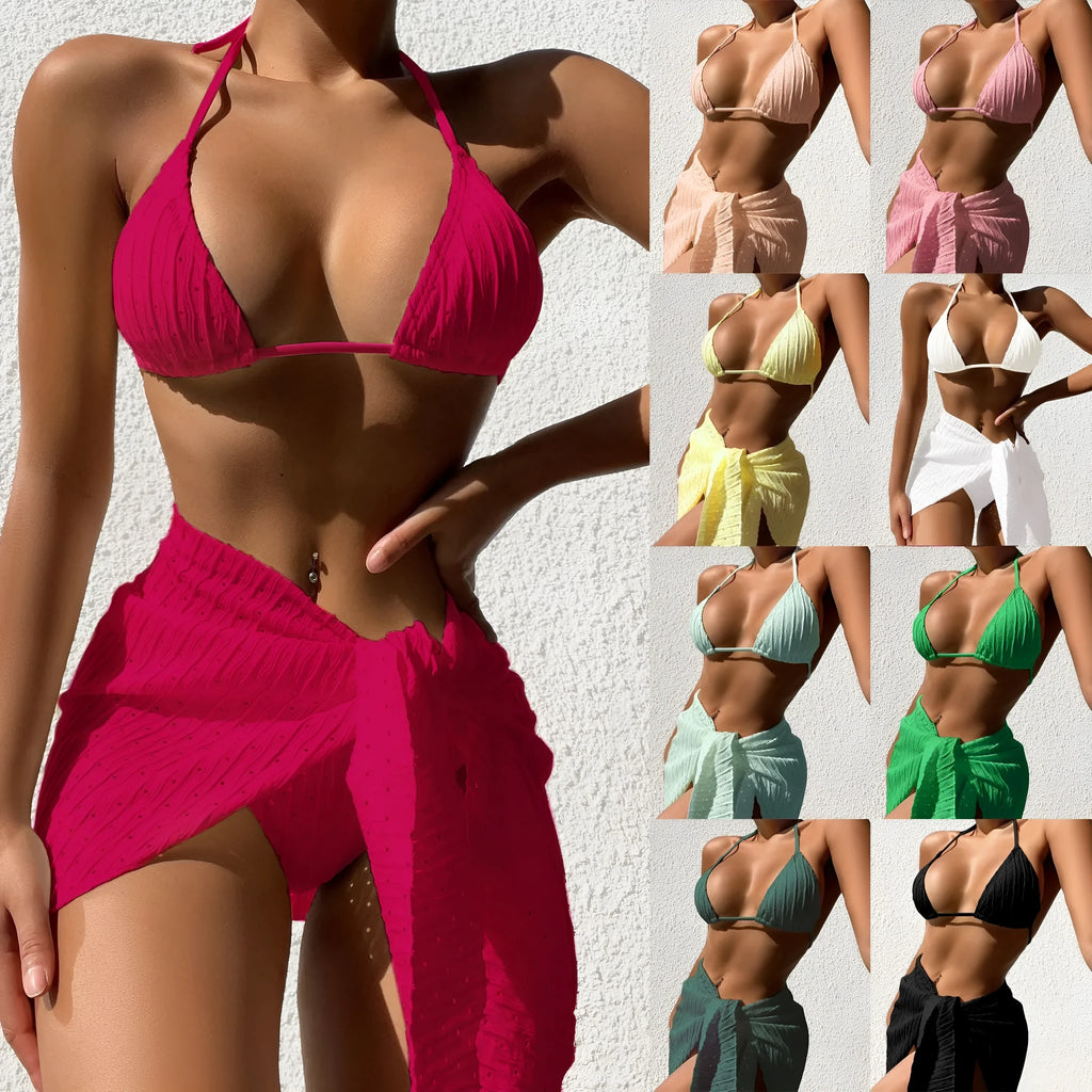 Women's halterneck bikini swimsuit set in a solid colour with a matching mesh skirt.