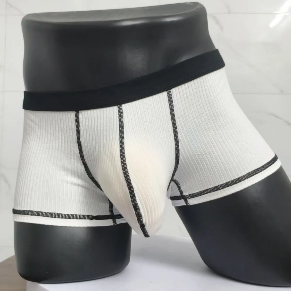 Men's solid colour thin fit boxers showing breathable fabric and body shaping design.