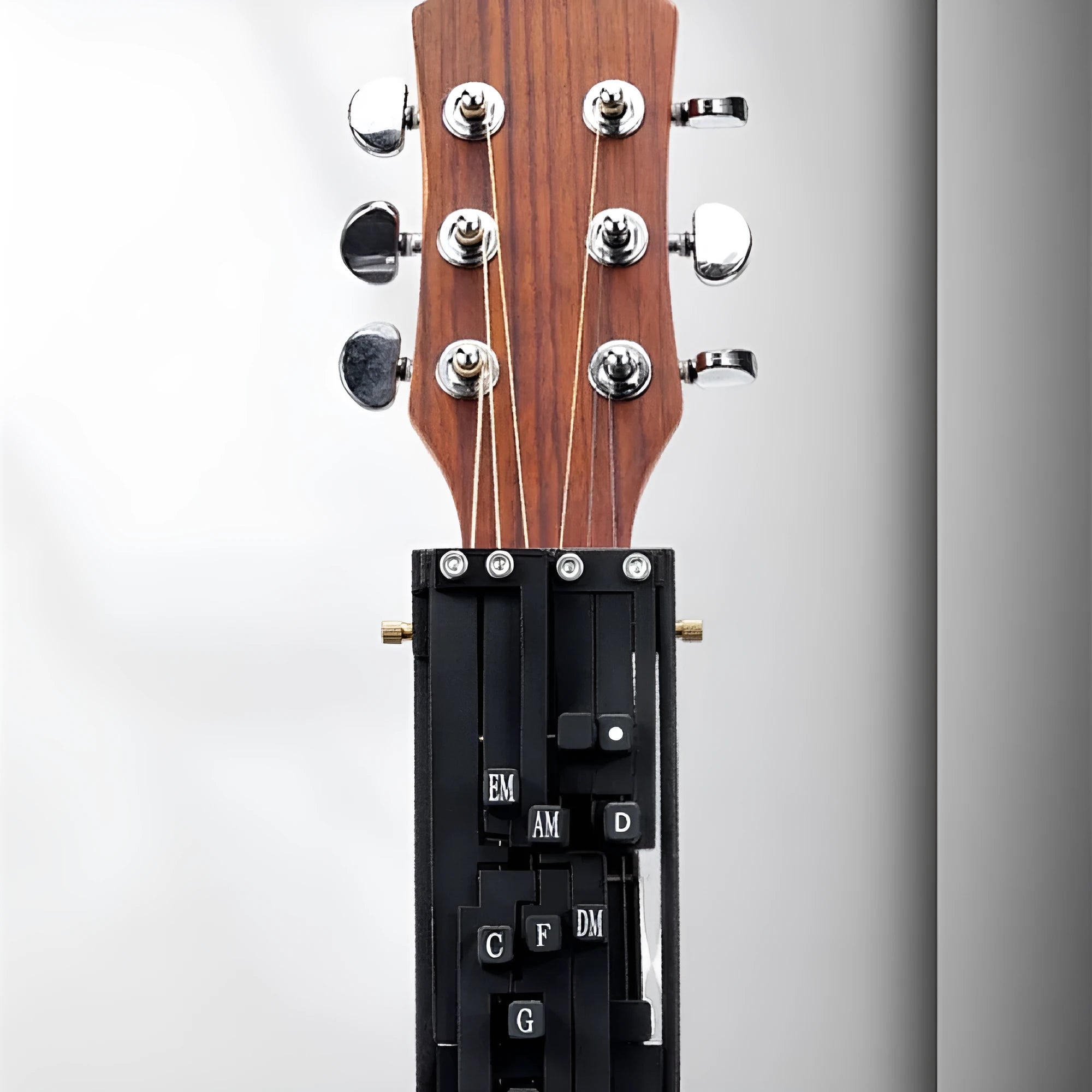 Automatic guitar chord capo device for beginner folk guitar players showing double chord mechanism