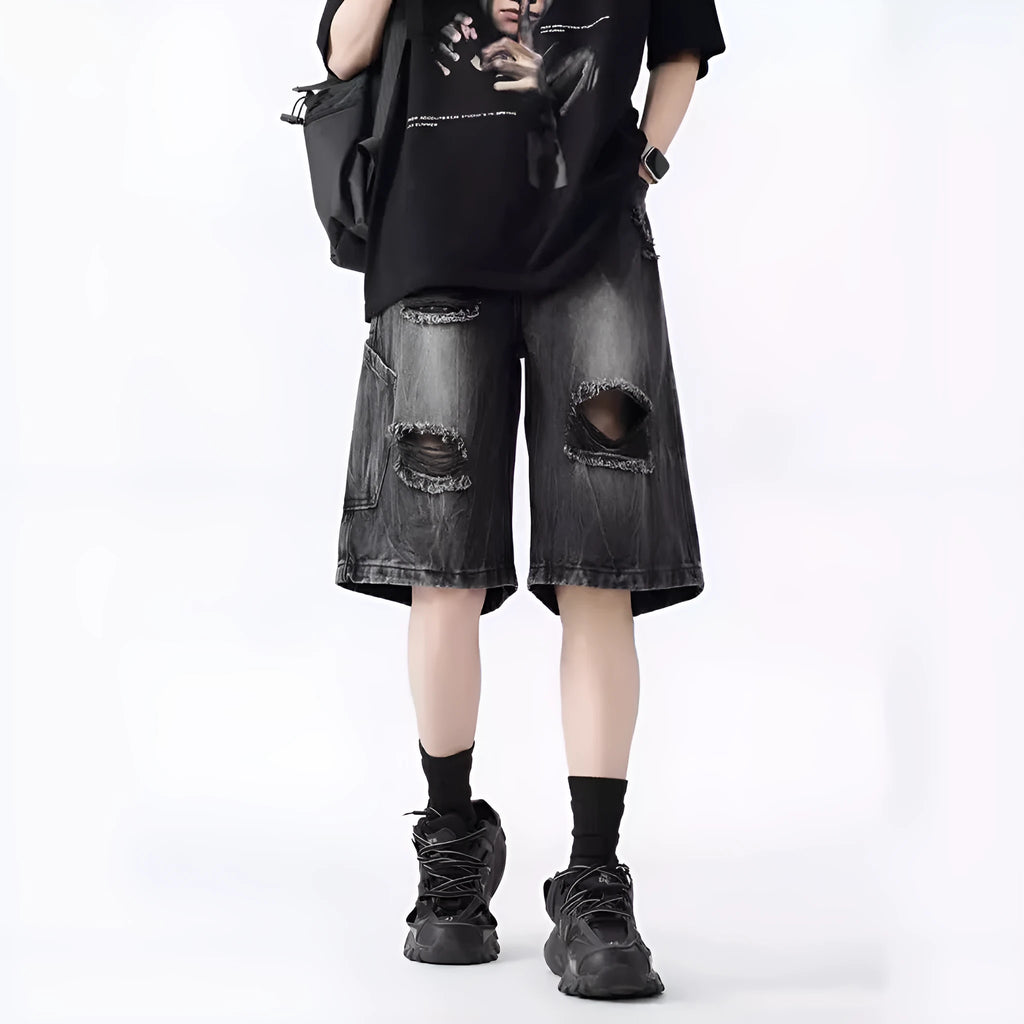 Men's ripped denim shorts with washed finish in black and blue colours showing loose fit design