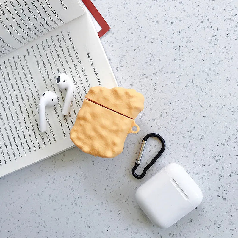 Silicone AirPod case with cartoon animal design in multiple colour options on a table.