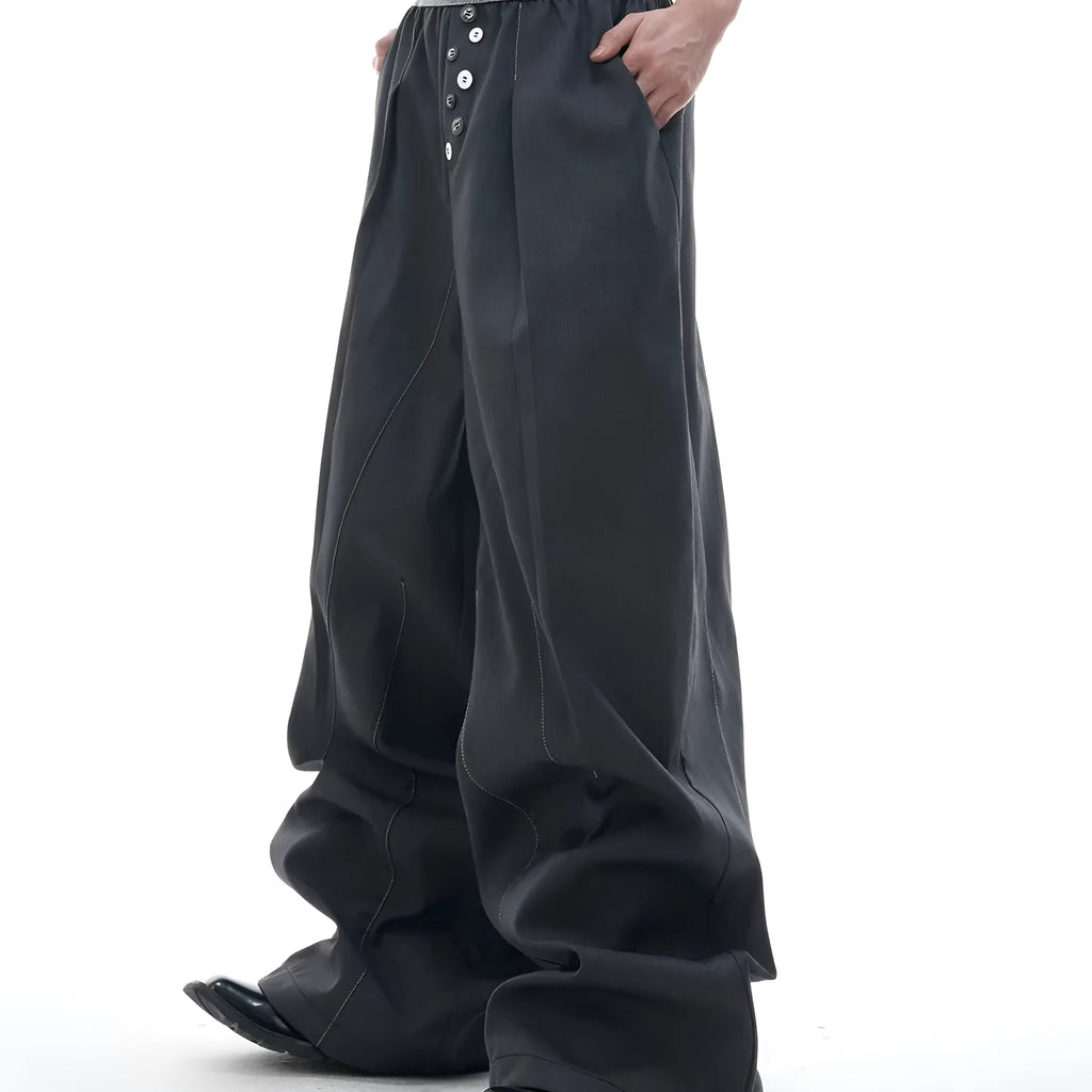Men's straight-leg casual trousers with drooping design and button detail in black or grey