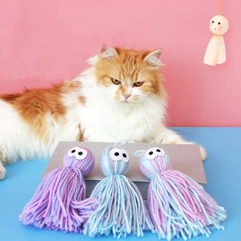 Bite-resistant wool cat ball toy in blue-grey, pink and blue, or pink and purple colour options.
