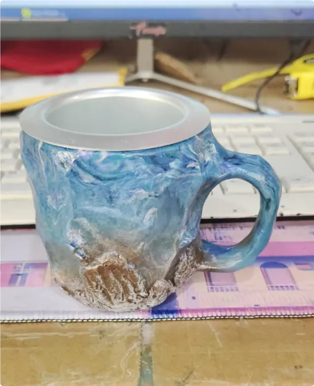 Purple and blue resin coffee mug with crystal texture and handle on wooden table