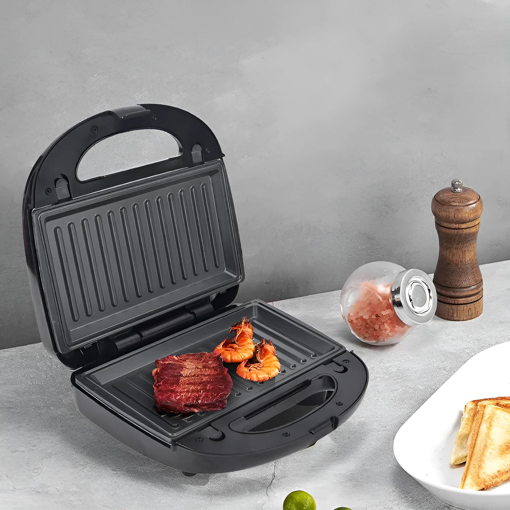 Black electric sandwich pan with brushed stainless steel top cover and exchangeable non-stick baking pans