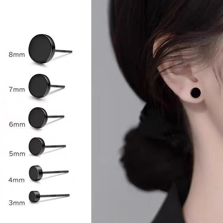 A pair of small, round, flat sterling silver stud earrings for cartilage piercing on a plain background.