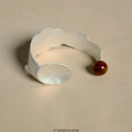 Small round spoon stewed pork jewellery set showing ring and bracelet with diamond-shaped electroplated alloy charms