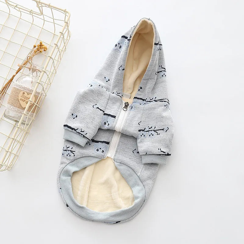 Blue cotton dog sweater with zipper front closure and dog pattern print shown on a pet
