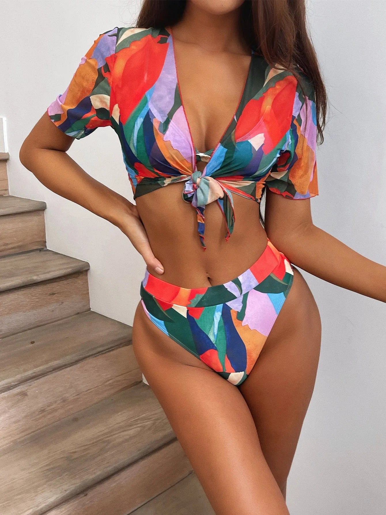 Red women's printed split design swimsuit or bikini made from nylon fabric.