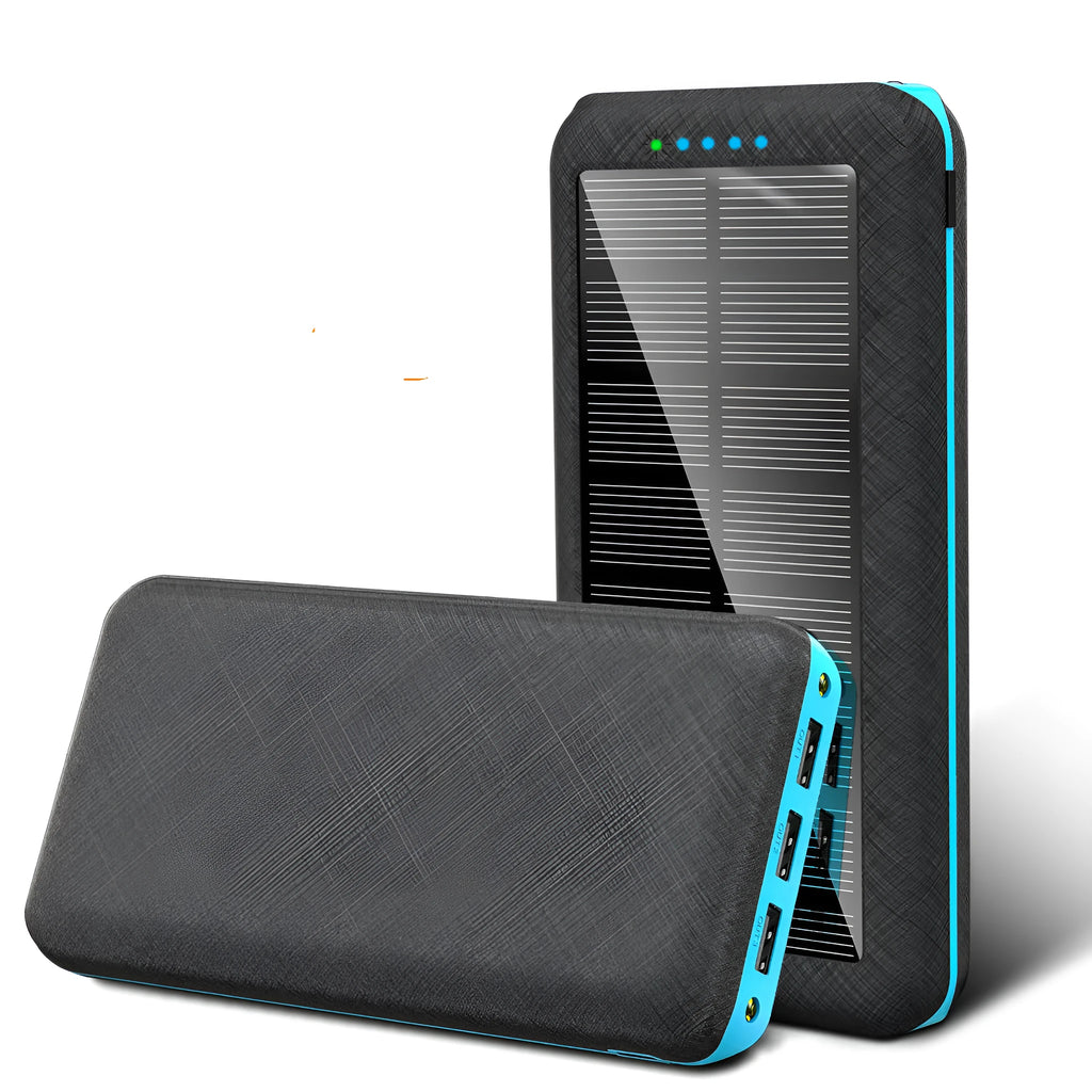 Black portable solar power bank with wireless charging pad and three USB ports on a wooden surface.